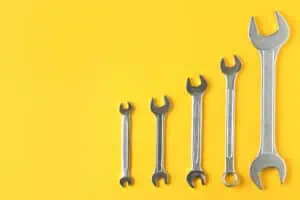 maintenance marketing strategy, wrench on yellow background