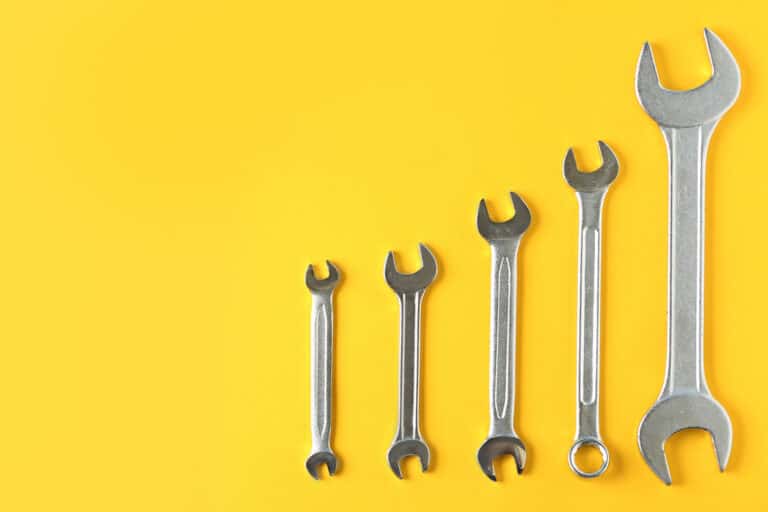 maintenance marketing strategy, wrench on yellow background