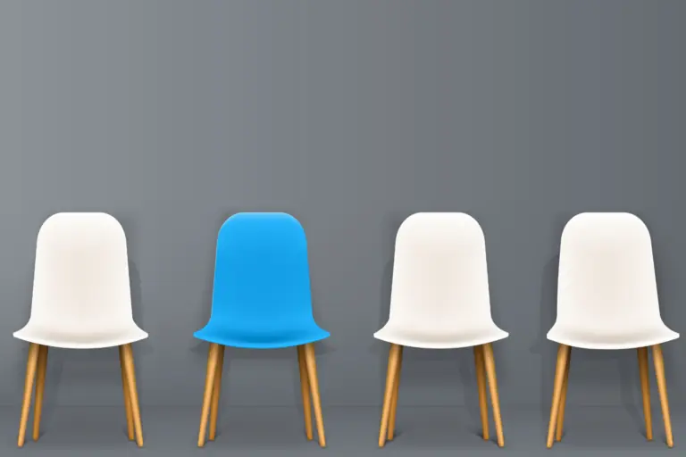 three white chars one blue chair against a wall