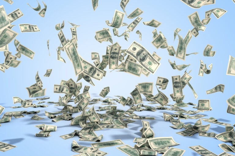 Are you wasting your online marketing budget. Money flying in the air on blue background