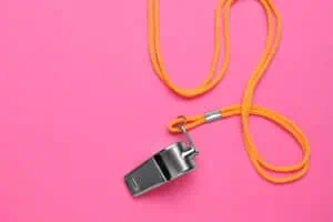 whistle on pink background, marketing coach