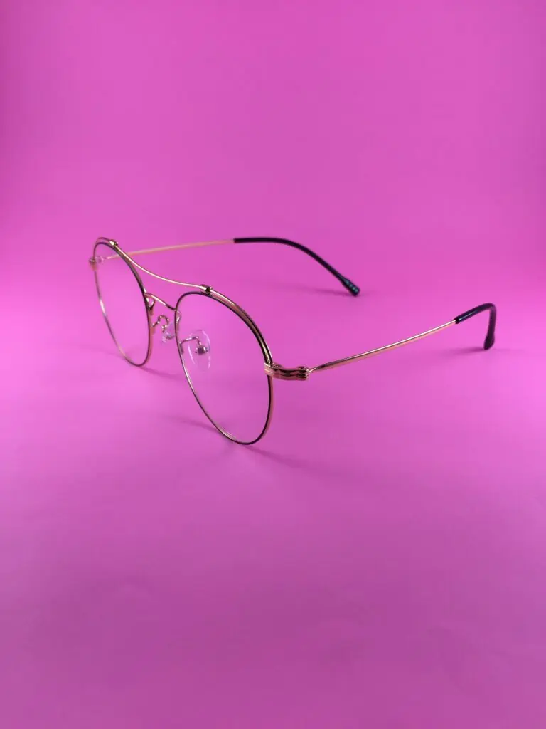 metal framed glasses on purple background