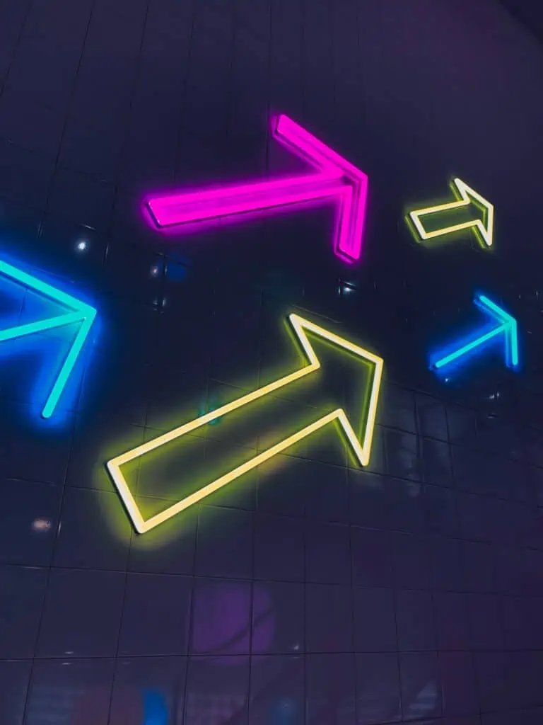 neon light arrows on a wall