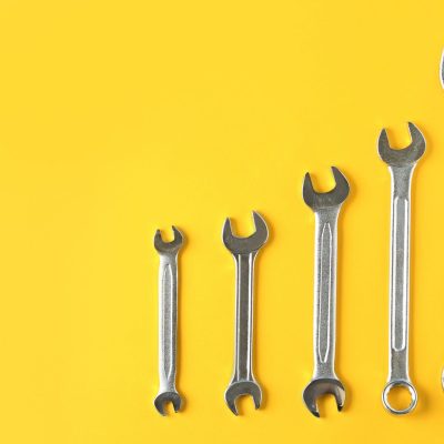 maintenance marketing strategy, wrench on yellow background