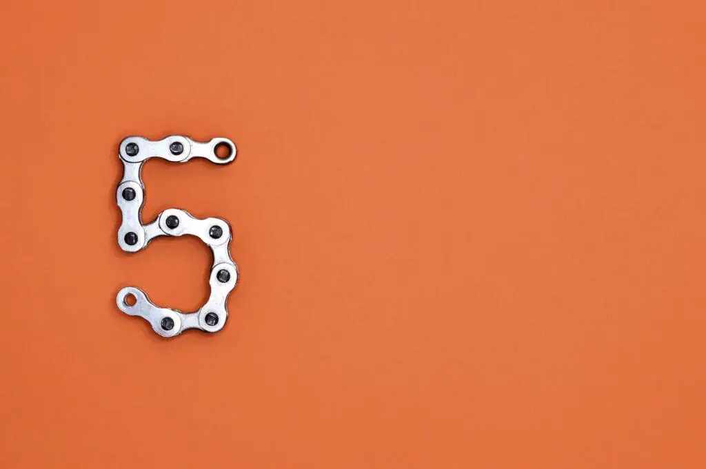 metal letter 5 on orange background